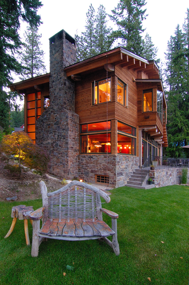 Inspiration for a brown rustic house exterior in Seattle with wood cladding.