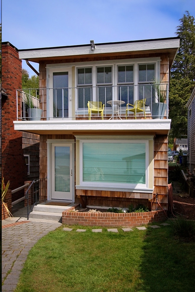 This is an example of a coastal house exterior in Seattle with wood cladding.