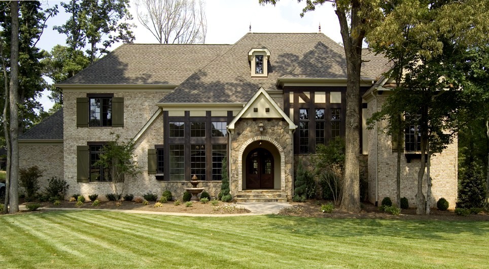 Large traditional gray two-story mixed siding house exterior idea in Charlotte with a clipped gable roof and a shingle roof