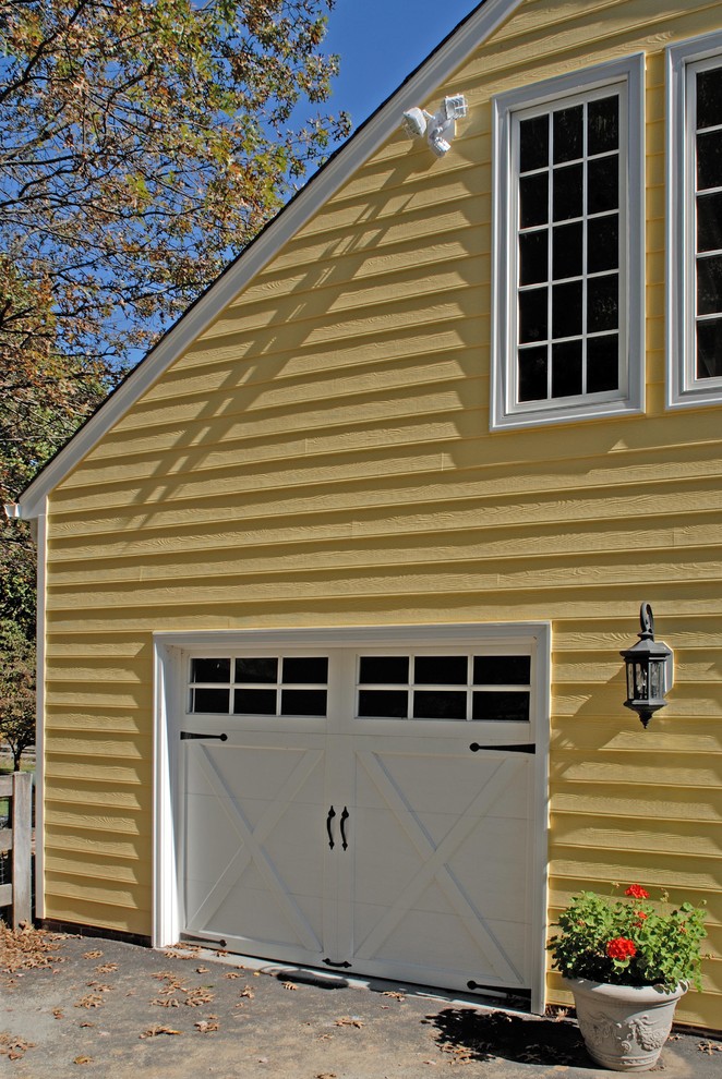 Inspiration for a large and yellow classic two floor house exterior in DC Metro with wood cladding and a pitched roof.