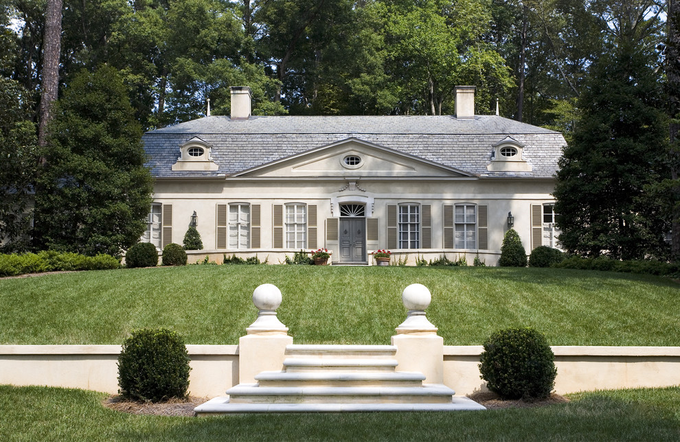 Example of a large classic gray two-story stucco gable roof design in Atlanta