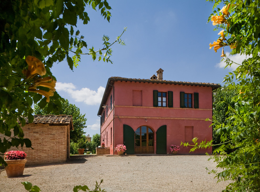 Inspiration for a mid-sized mediterranean pink two-story stucco exterior home remodel in New York