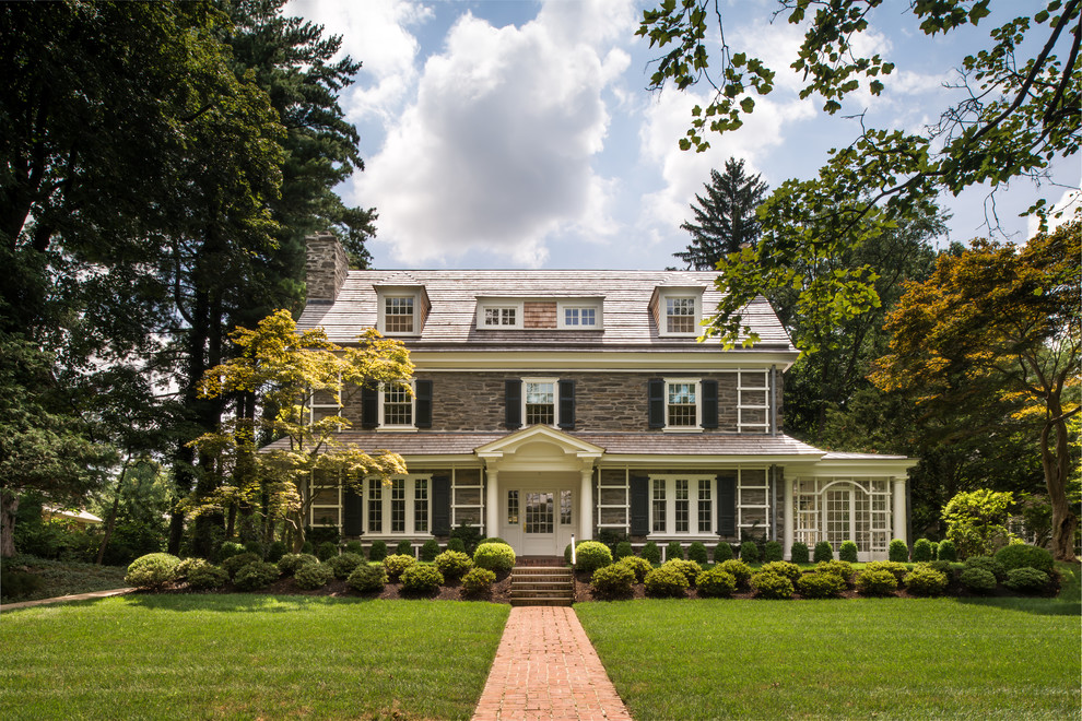 Mid-sized elegant gray three-story stone exterior home photo in Philadelphia with a shingle roof