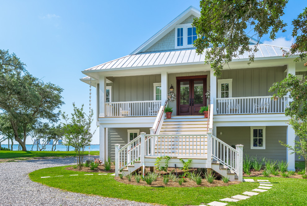 Example of a mid-sized beach style green three-story vinyl exterior home design in Atlanta