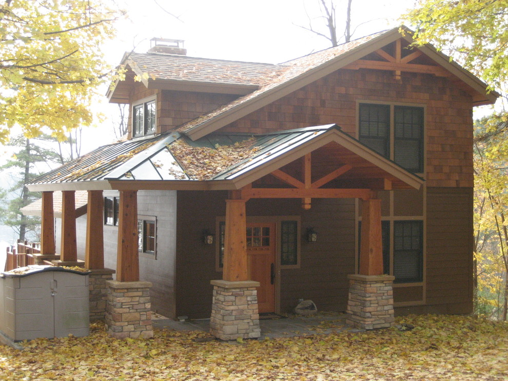 Example of a mid-sized mountain style multicolored two-story mixed siding gable roof design in Boston