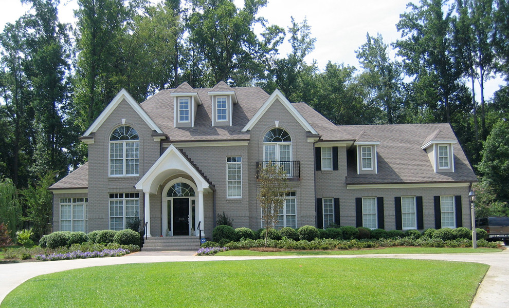 Large trendy gray two-story brick exterior home photo in Raleigh