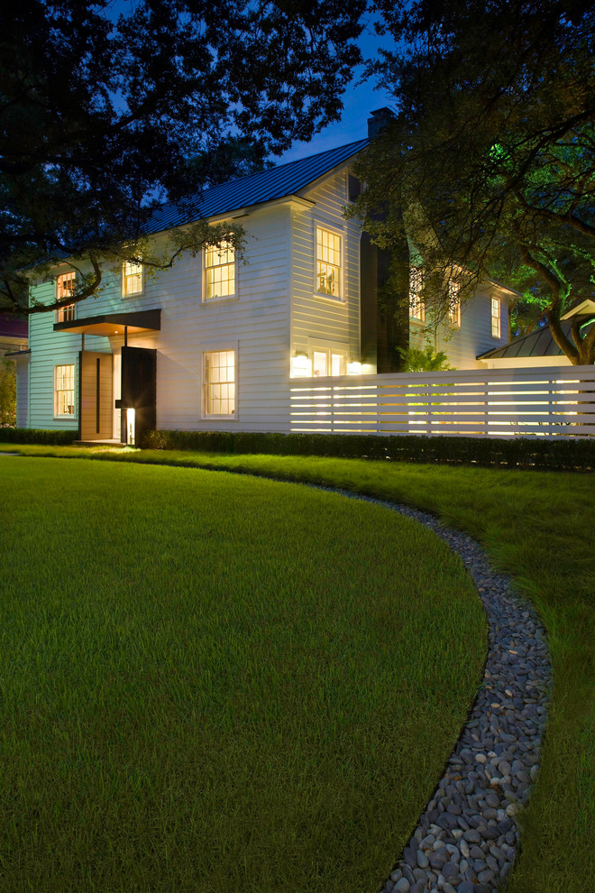 Design ideas for a white classic two floor house exterior in Austin with wood cladding.