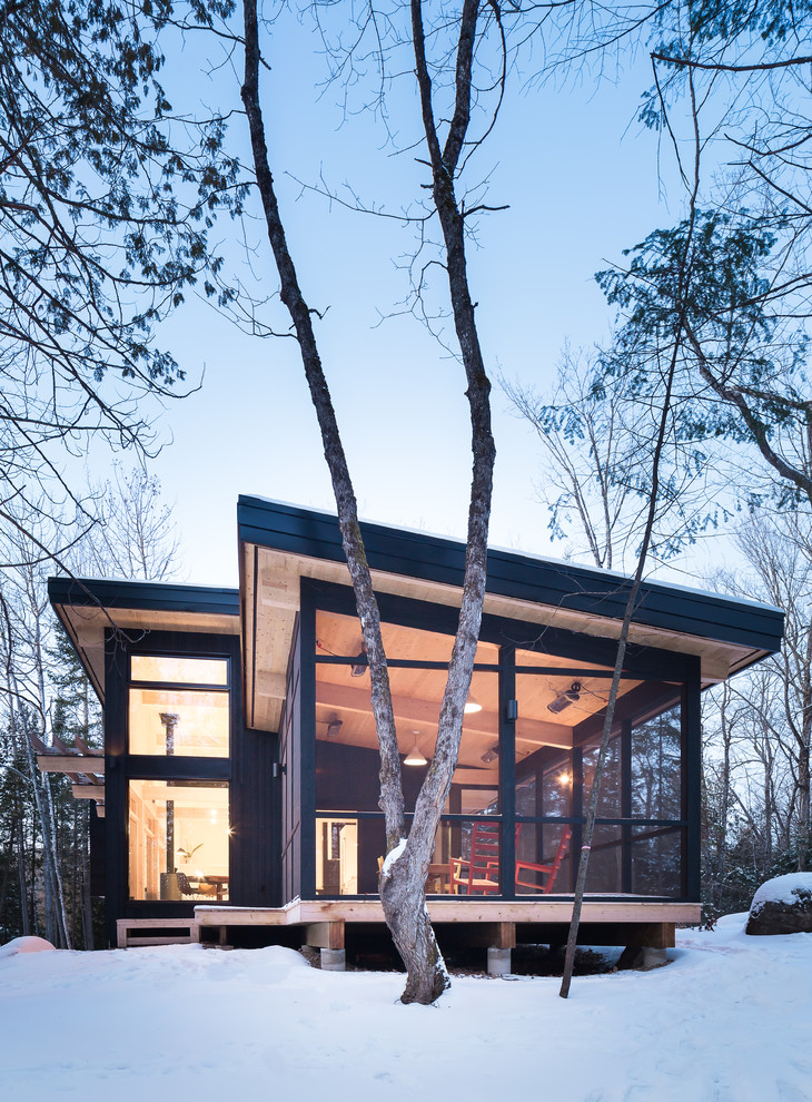 Example of a small mountain style black split-level wood exterior home design in Montreal
