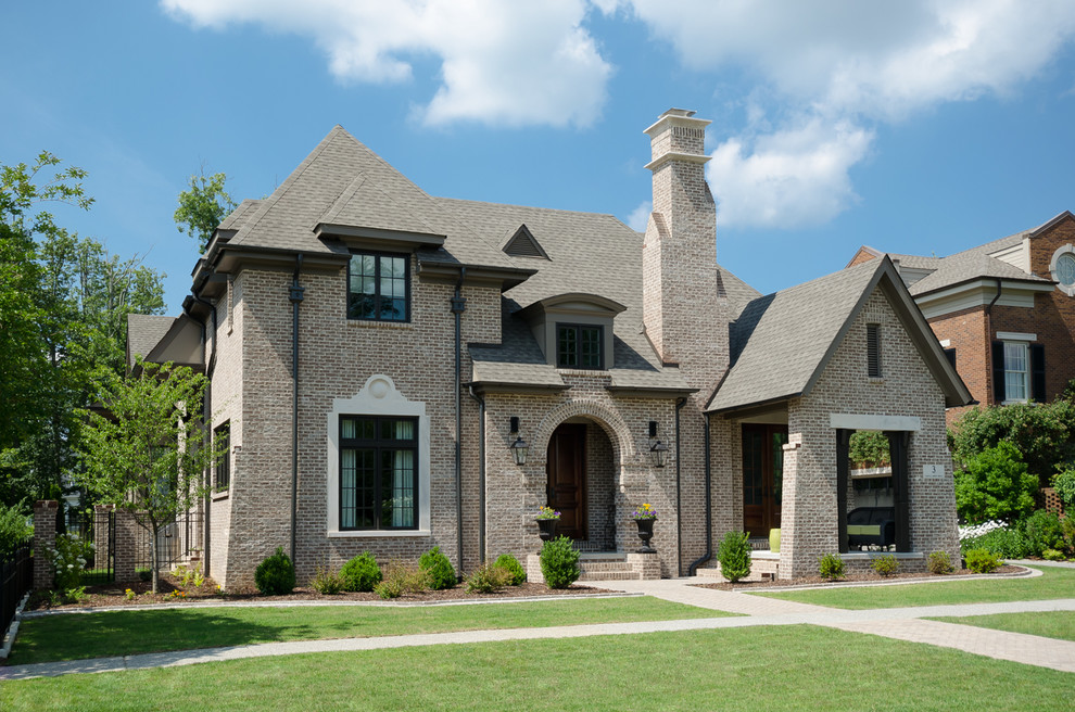 Example of a classic two-story brick exterior home design in Birmingham