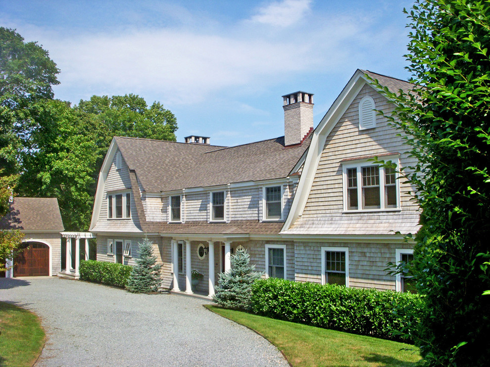 Example of a large classic gray two-story wood exterior home design in Providence with a gambrel roof