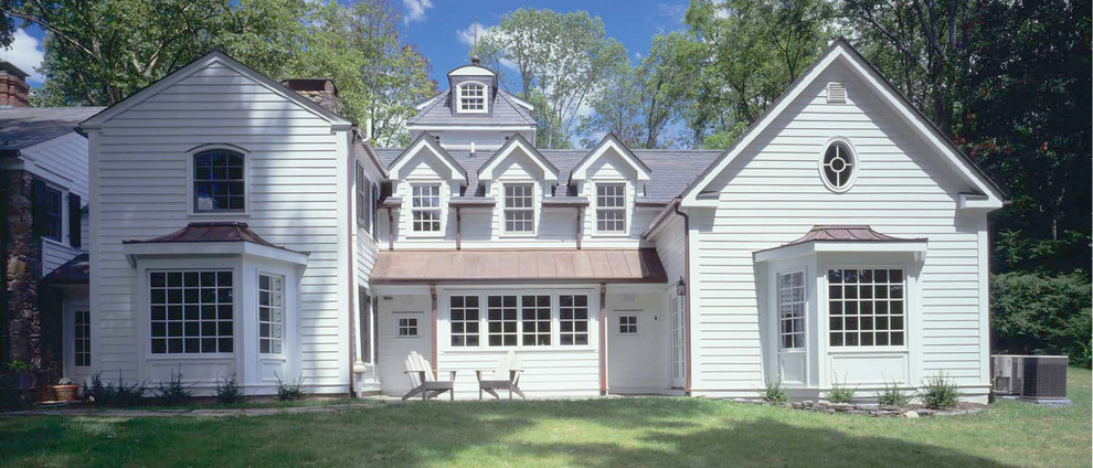 Large and white traditional two floor house exterior in Philadelphia with wood cladding and a pitched roof.
