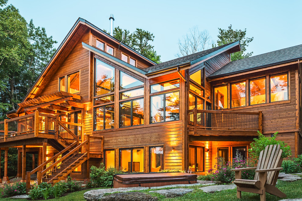 Transitional three-story wood exterior home photo in Montreal