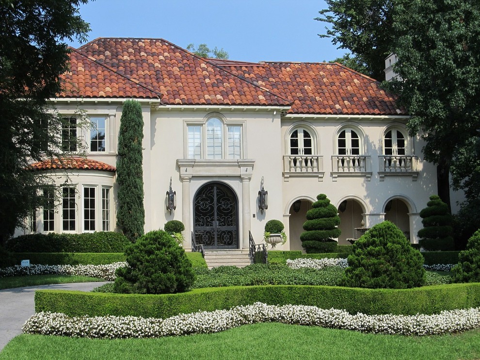Inspiration for a large and beige classic two floor render detached house in Miami with a hip roof and a tiled roof.