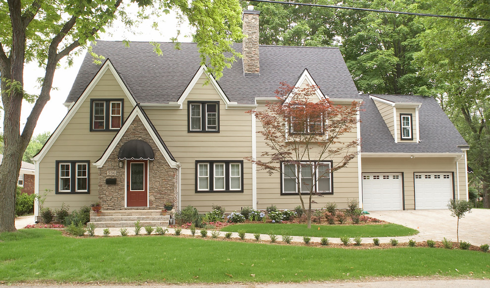 Exemple d'une façade de maison beige chic en panneau de béton fibré de taille moyenne et à un étage avec un toit à deux pans.