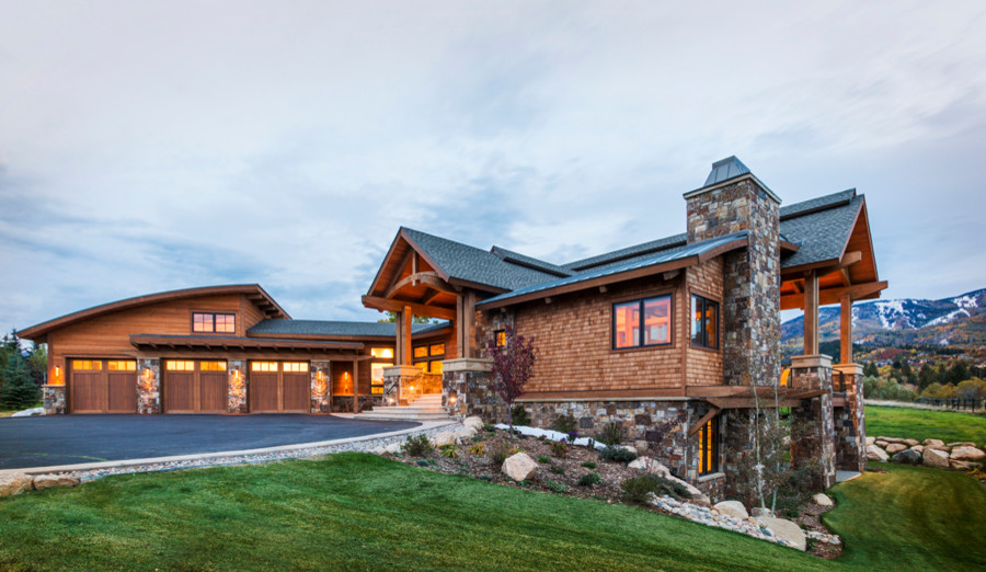 Example of a large mountain style brown two-story wood house exterior design in Denver with a shingle roof