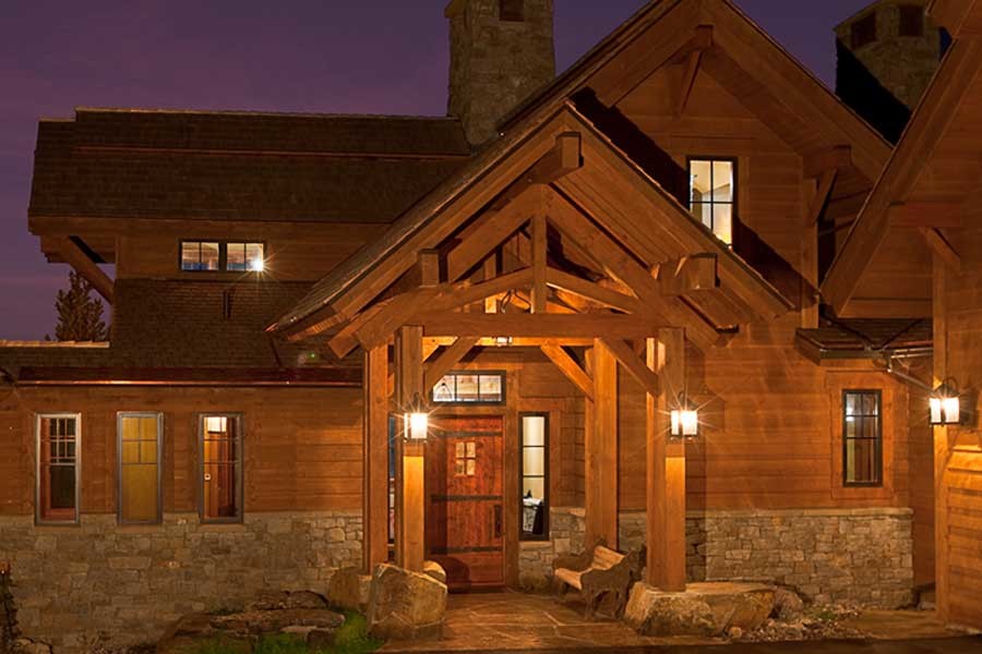 Inspiration for a medium sized and brown rustic house exterior in Other with three floors and wood cladding.