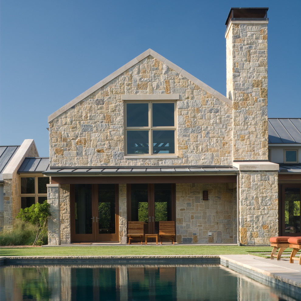 Ispirazione per la facciata di una casa contemporanea con rivestimento in pietra