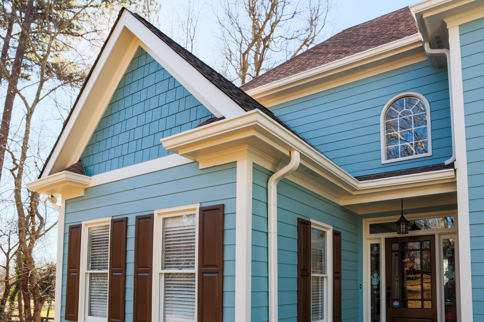 Example of a mid-sized eclectic blue two-story mixed siding gable roof design in Atlanta