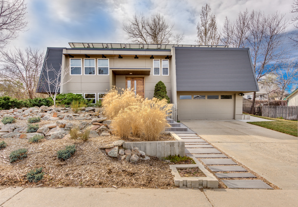 This is an example of a beige contemporary split-level detached house in Denver with a metal roof.