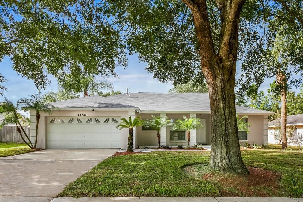 Inspiration for a medium sized and beige traditional bungalow render detached house in Orlando with a hip roof and a shingle roof.