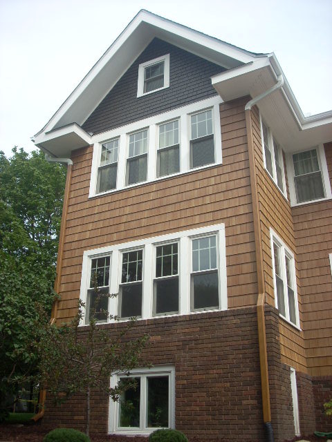 Example of a trendy brown wood exterior home design in Minneapolis