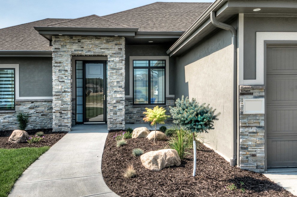 Example of a transitional gray exterior home design in Omaha