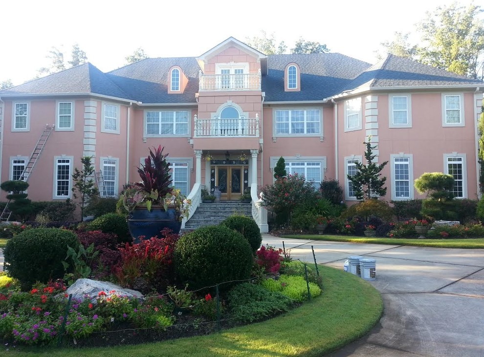 Photo of a large and brown classic two floor render house exterior in Atlanta with a pitched roof.