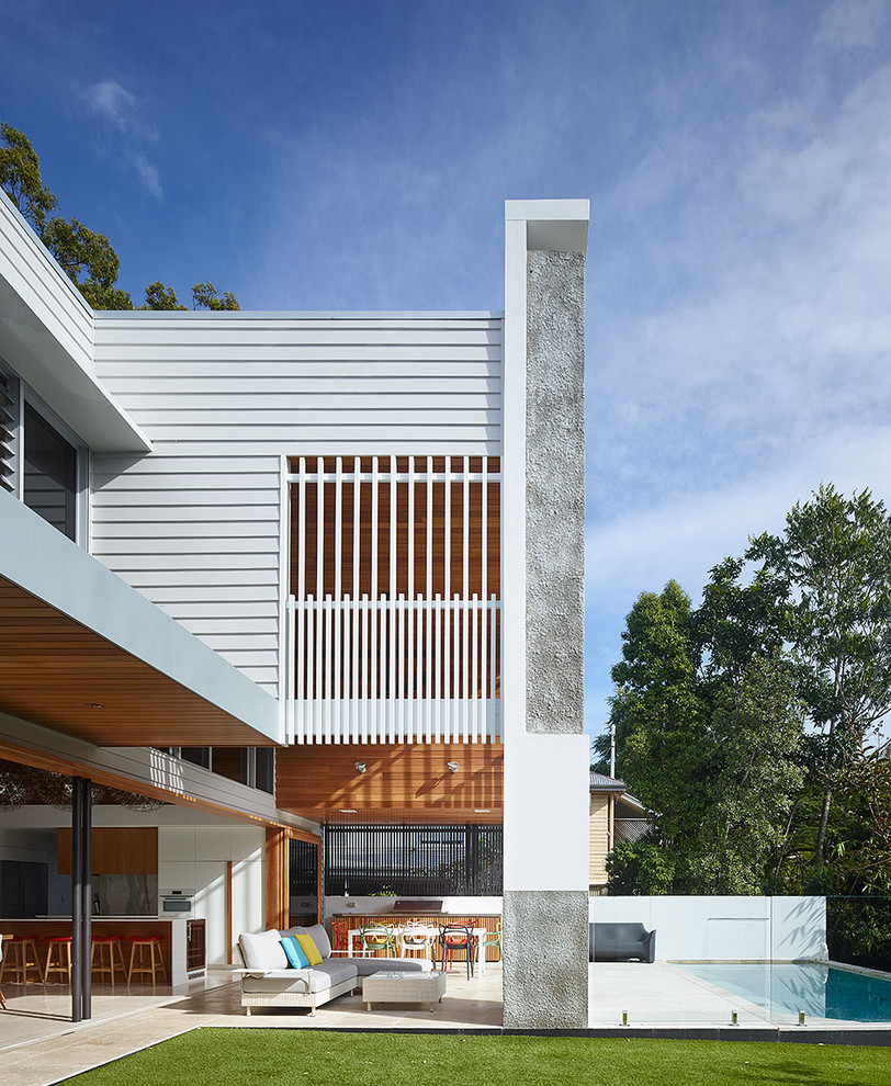 This is an example of a large and white contemporary two floor house exterior in Brisbane.