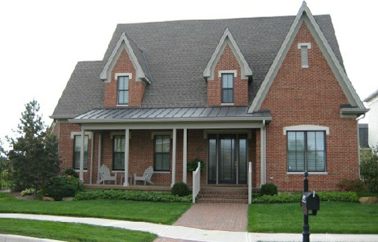 Example of a classic two-story brick exterior home design in Indianapolis