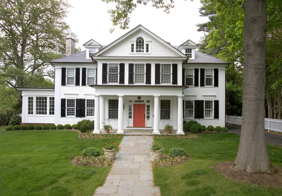 Large traditional white three-story wood exterior home idea in Other