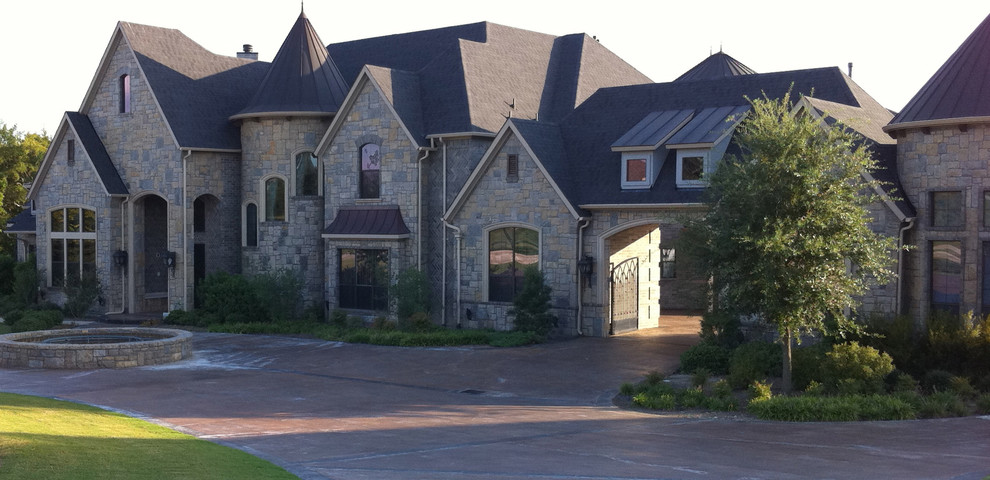 Huge elegant two-story stone gable roof photo in Dallas