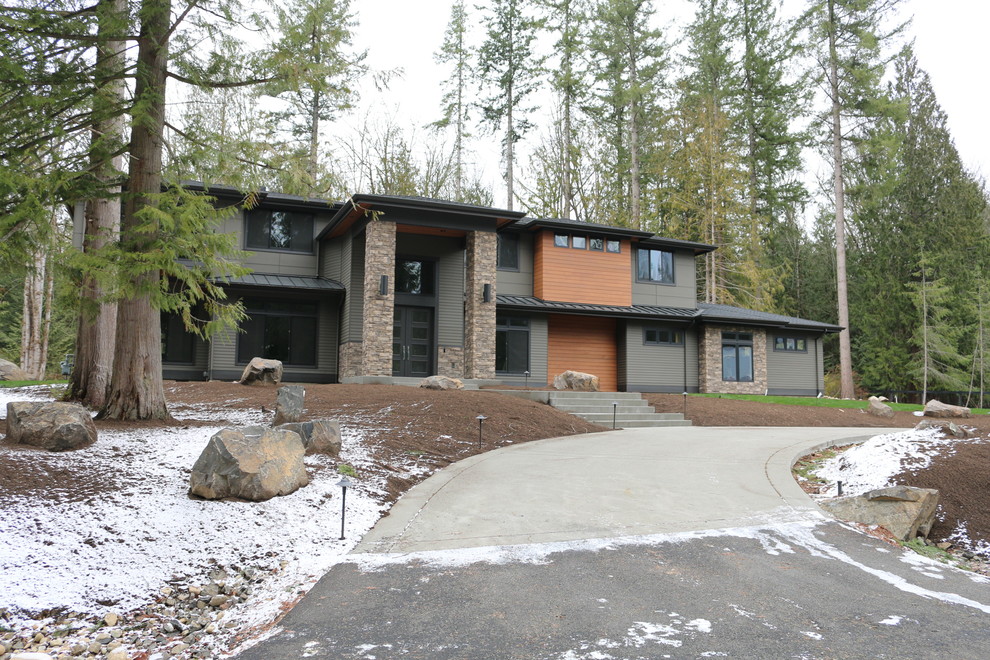 Large trendy green two-story vinyl house exterior photo in Seattle with a hip roof and a mixed material roof