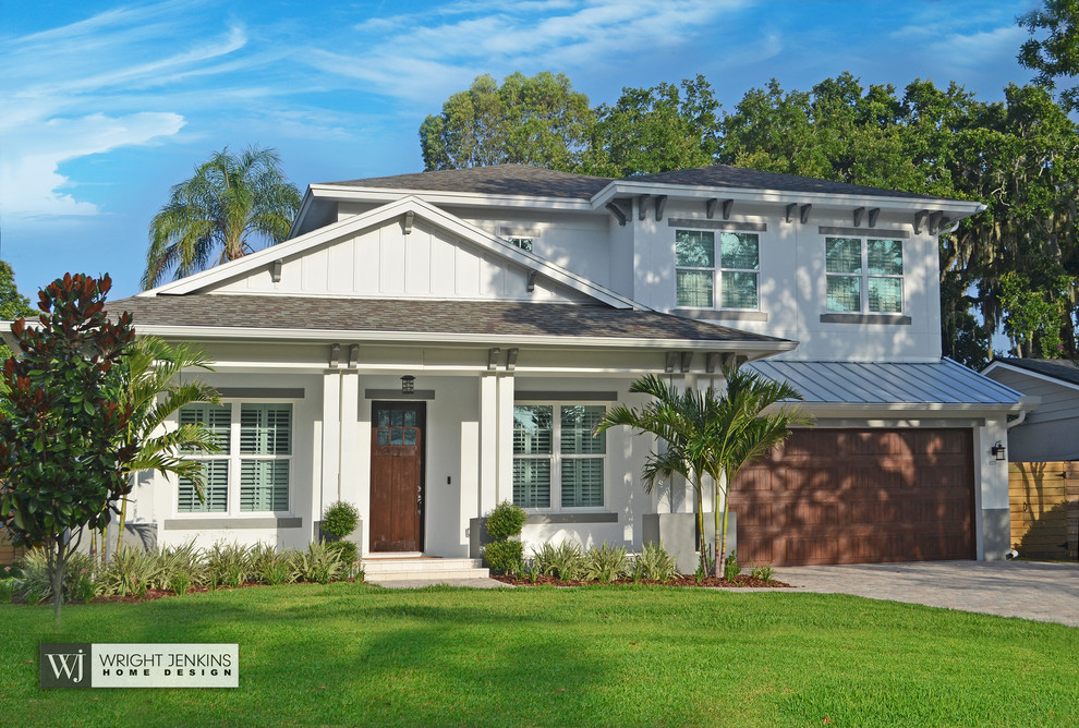 Inspiration for a mid-sized transitional white two-story mixed siding house exterior remodel in Orlando with a hip roof and a mixed material roof