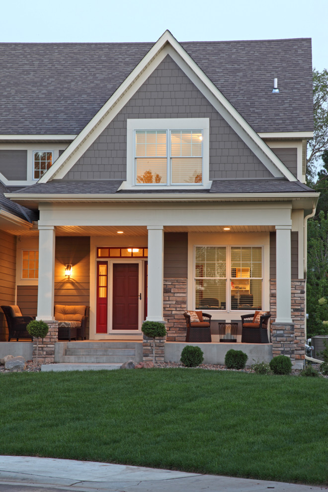 Example of a mid-sized classic gray two-story stone gable roof design in Minneapolis