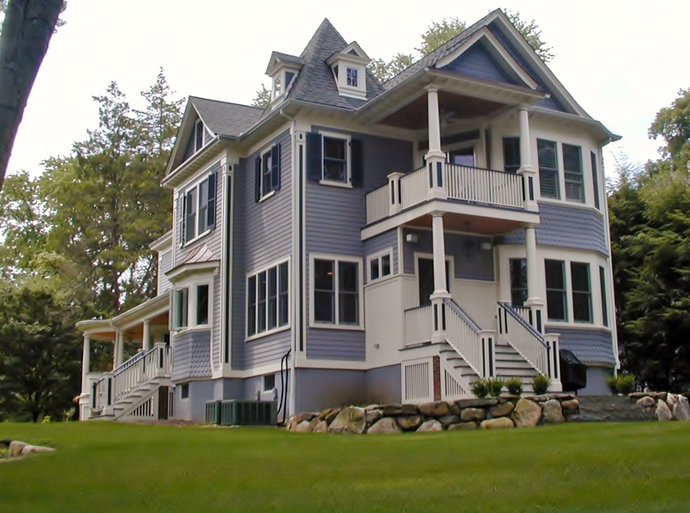 Inspiration for a huge timeless blue three-story wood gable roof remodel in New York