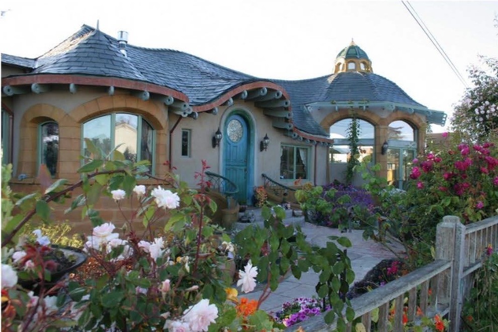 Inspiration for a mid-sized eclectic beige one-story stucco house exterior remodel in San Francisco with a tile roof