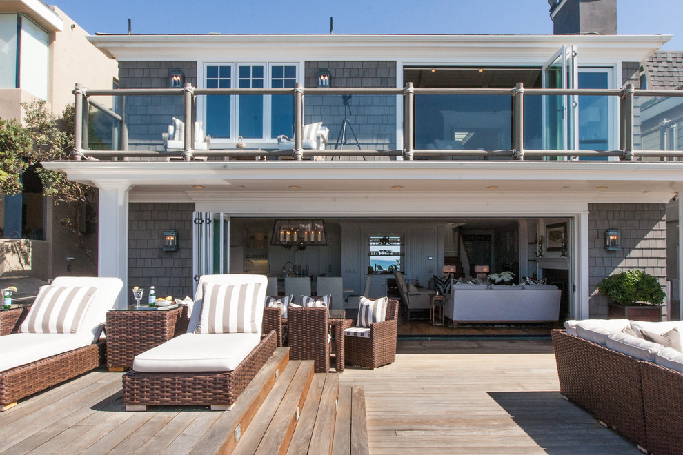 Inspiration for a mid-sized coastal gray two-story wood exterior home remodel in Orange County