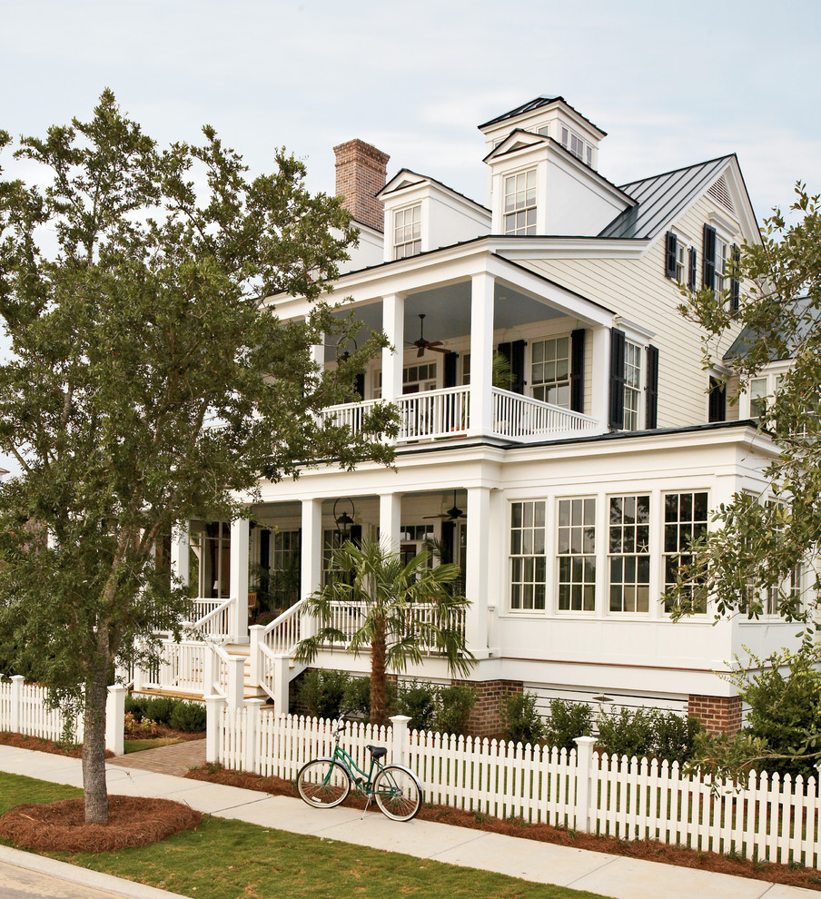Inspiration for a white traditional house exterior in Atlanta with three floors.