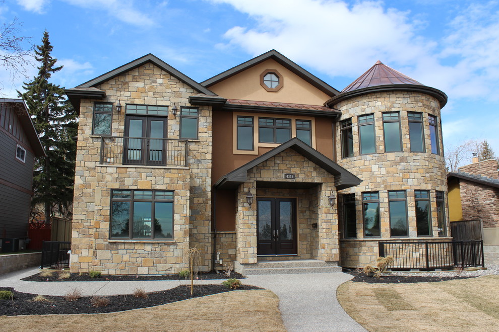 Inspiration for a large and brown eclectic two floor house exterior in Calgary with mixed cladding.