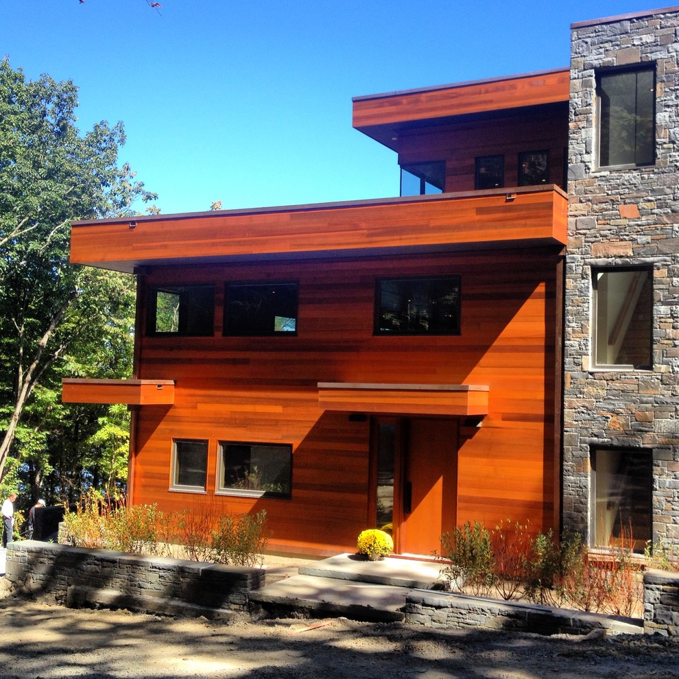Design ideas for a large contemporary house exterior in New York with three floors and wood cladding.