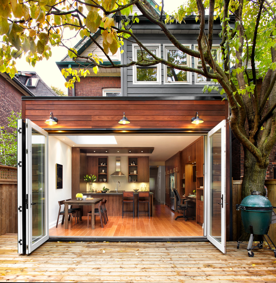 Mid-sized transitional three-story wood exterior home photo in Toronto
