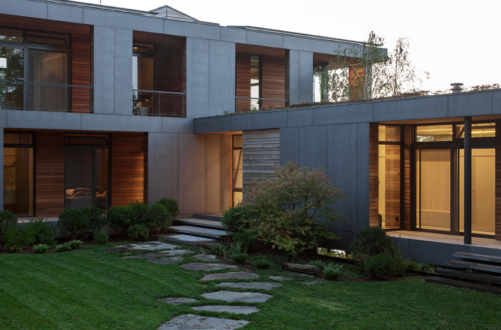 Modelo de fachada gris actual con revestimiento de aglomerado de cemento
