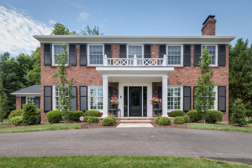 Elegant red two-story brick house exterior photo in Louisville