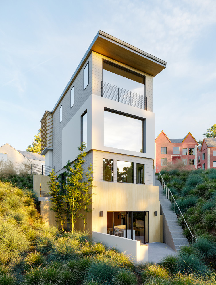 Réalisation d'une grande façade de maison multicolore minimaliste en bois et bardage à clin à trois étages et plus avec un toit en appentis.