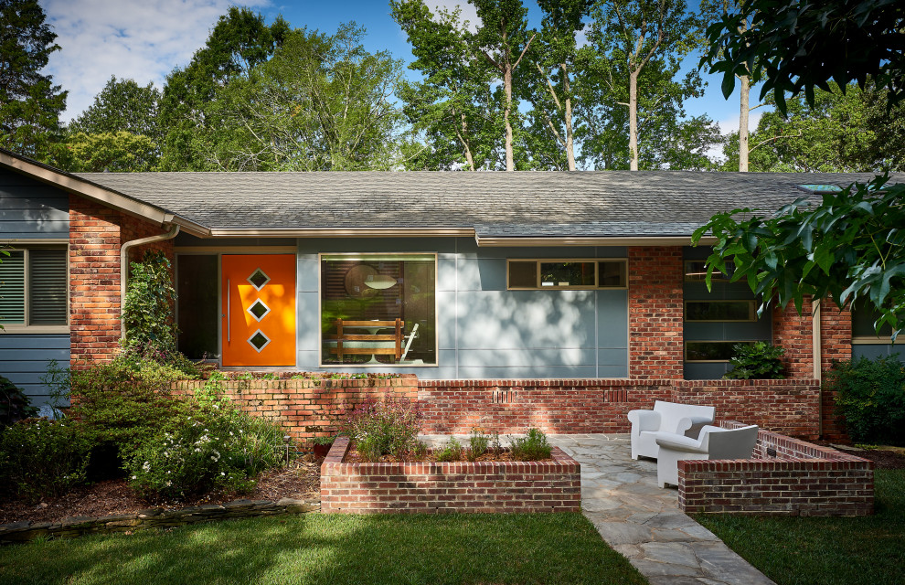 Large 1960s blue two-story house exterior idea in Charlotte with a shingle roof