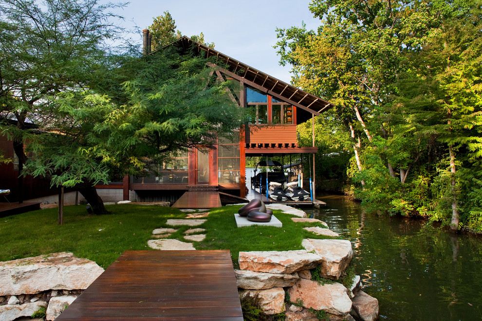 Inspiration for an eclectic house exterior in Austin with wood cladding.