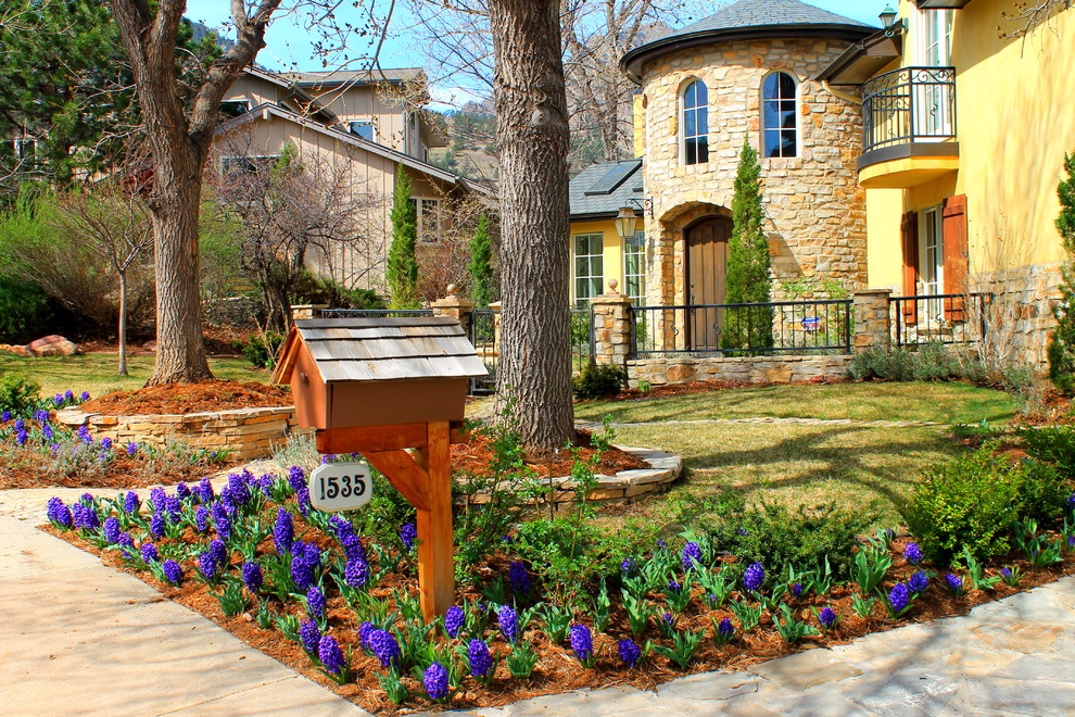 Example of a tuscan stone exterior home design in Denver