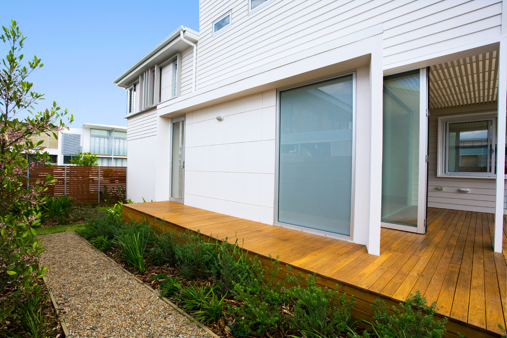 This is an example of a white contemporary two floor house exterior in Sydney with concrete fibreboard cladding.