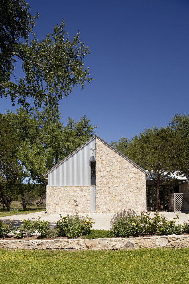 This is an example of a rustic house exterior in Austin with metal cladding.