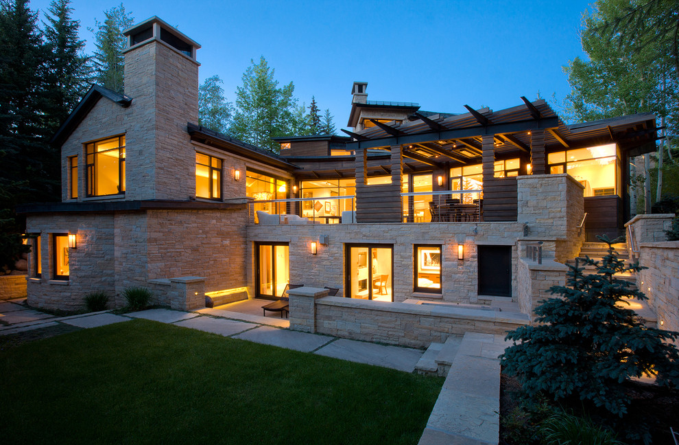 This is an example of a large modern two floor detached house in Denver with stone cladding, a pitched roof and a shingle roof.